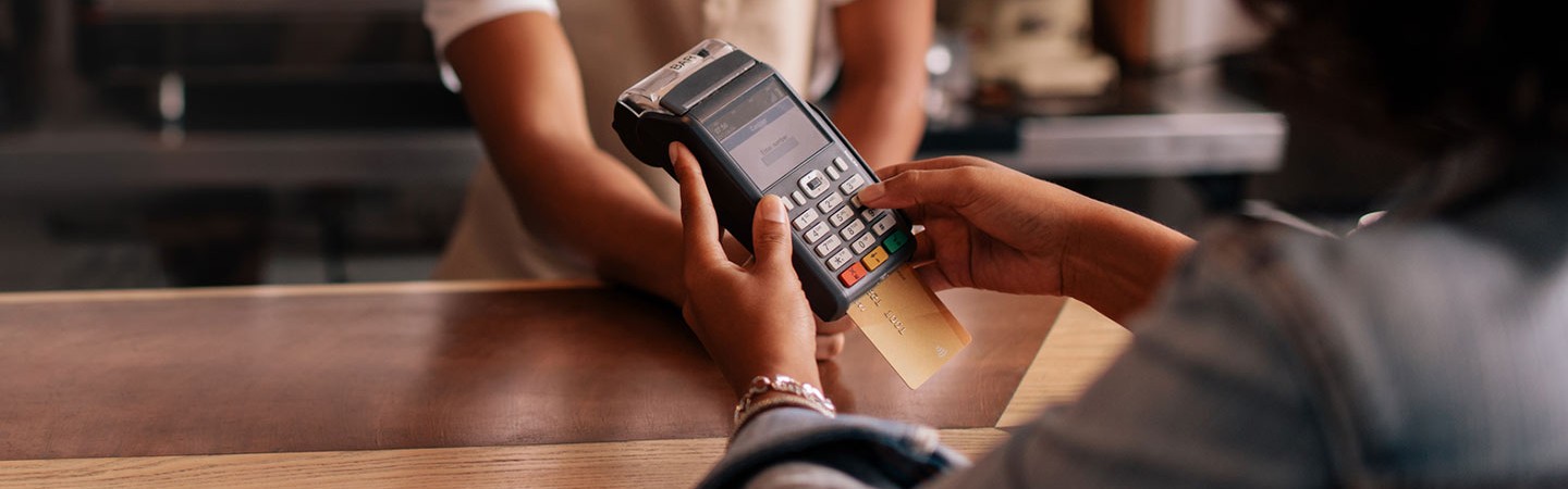 a woman making a credit/debit card payment