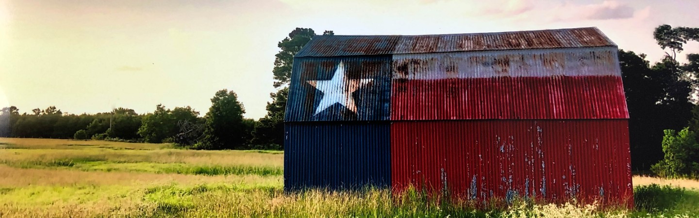 barn with the texas state flag painted on it by Danny Pickens