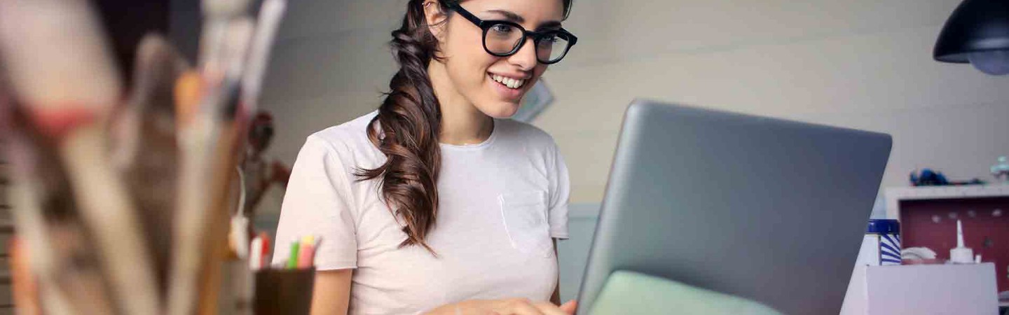 artist working on her laptop