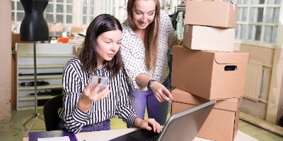 two business owners reviewing online websites