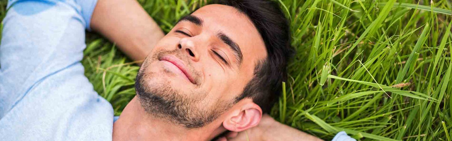 a man laying in grass