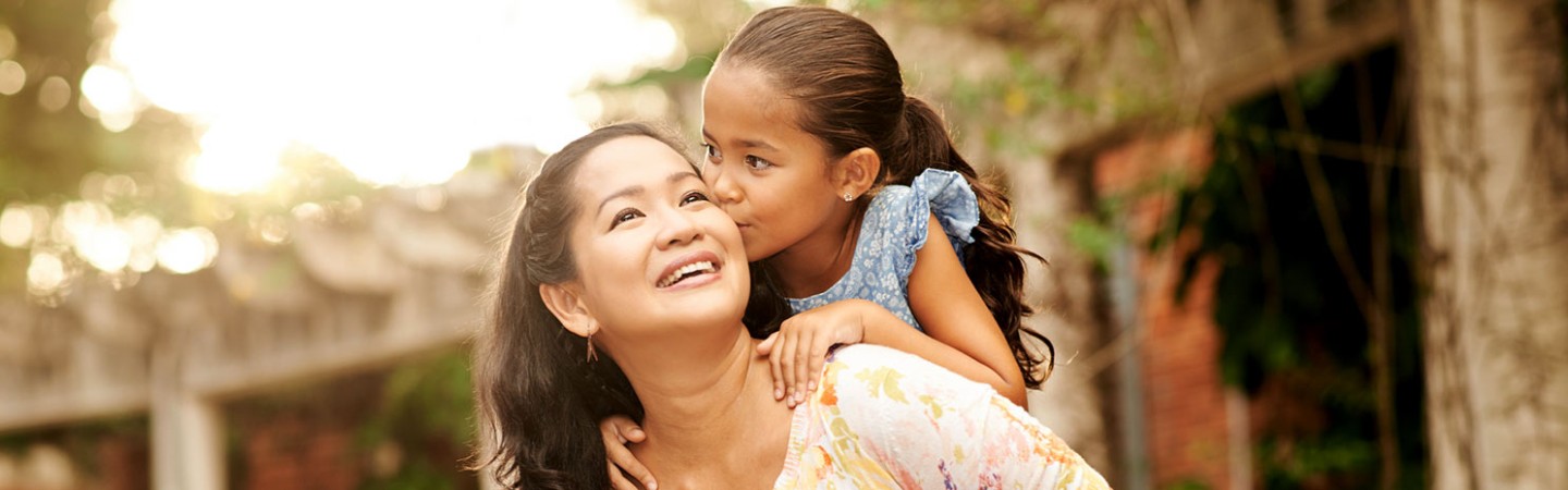 a daughter kissing her mother's cheek