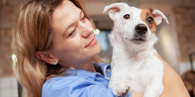 a woman holding her dog