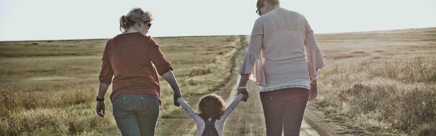 mother, child and grandmother walking