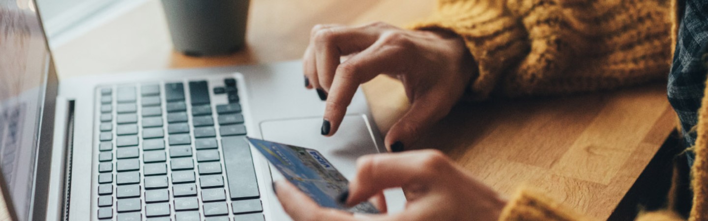 a woman making a payment with her debit/credit card